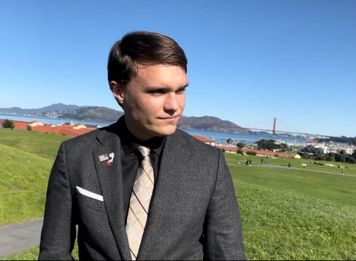 Kyle Langford at a grassy overlook with the Golden Gate Bridge behind him
